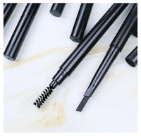 a set of black brow pencils on a marble surface