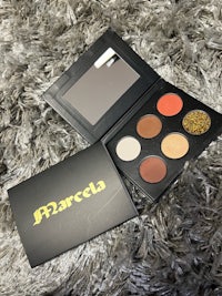 marcela eyeshadow palette on a fur rug