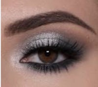 a woman's eye with a silver eyeshadow