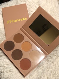 a makeup palette with a gold box on it