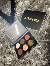 an eyeshadow palette on a fur rug