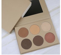 a box with a set of eyeshadow palettes on a white surface