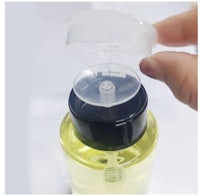 a person holding a plastic bottle with a lid on it