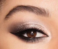 a close up of a woman's eye with a smokey eye