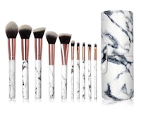 a set of makeup brushes in a marble case