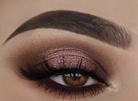 a close up of a woman's eye with a brown smokey eye