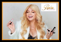 a woman with long blonde hair is holding a lipstick