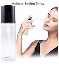 a woman is holding a bottle of makeup setting spray