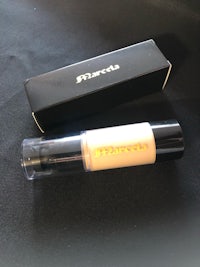 a bottle of concealer with a box next to it