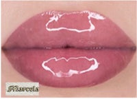 a close up of a woman's lips with white liquid on them